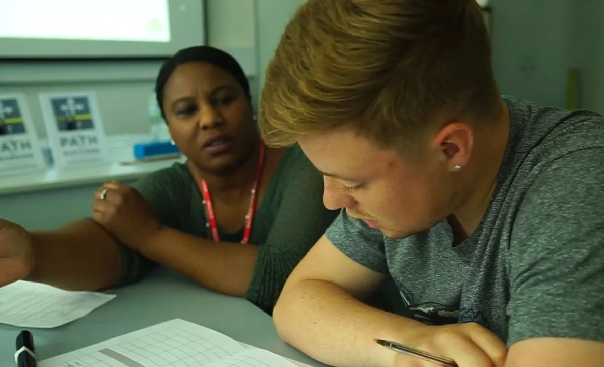 Olive Pellington coaching a student one-to-one during a school session