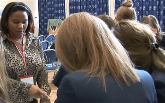 Olive Pellington leading a workshop with students in a school hall
